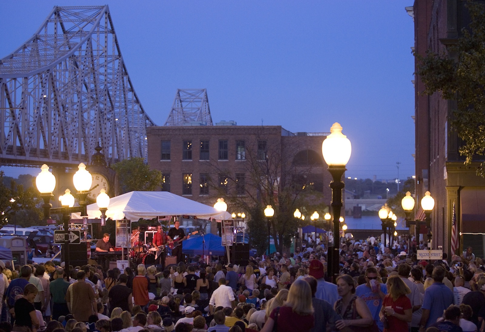a crowd of people at a blues festival listening to the rythm and blues and enjoying different food and drinks