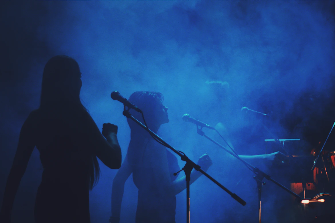 ladies singing under a blue light