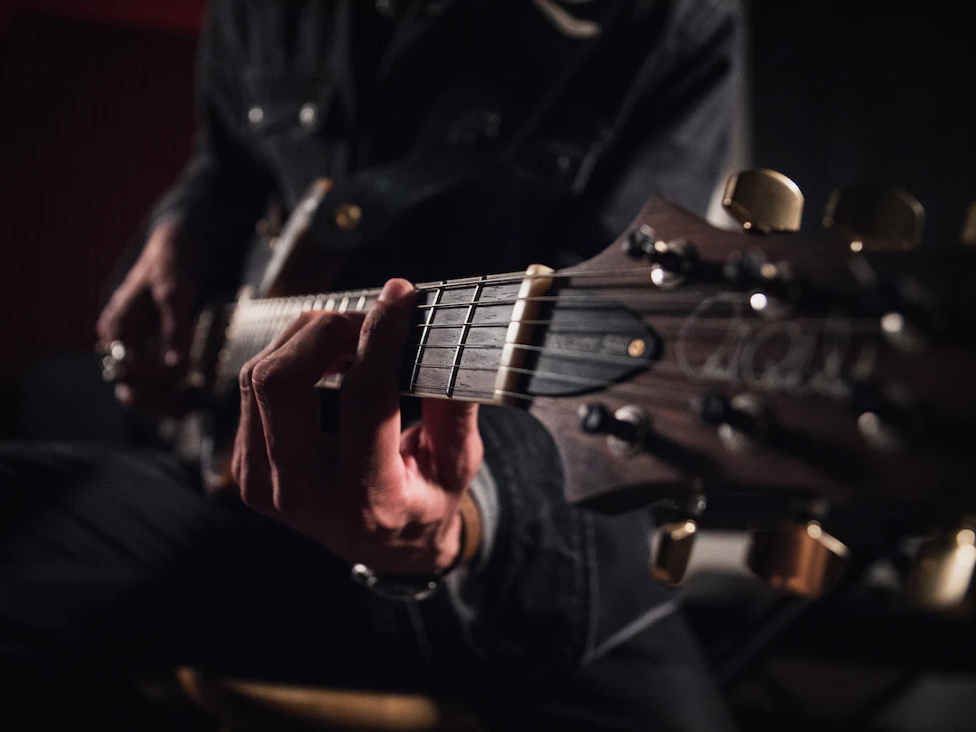  a man playing the blues on a guitar